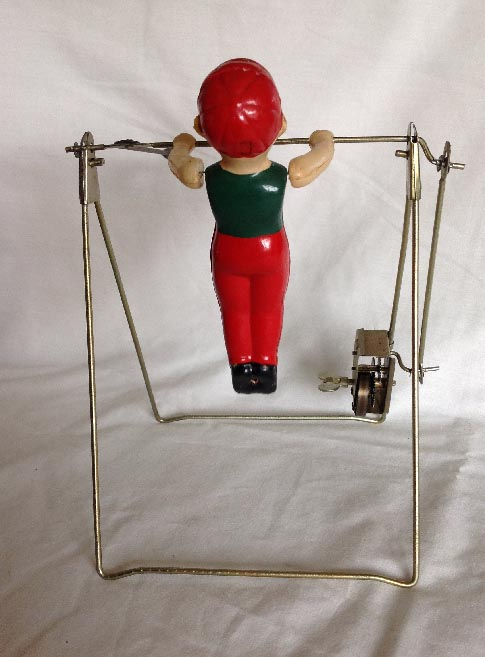 vintage clock work wind up toy with celluloid acrobat gymnast